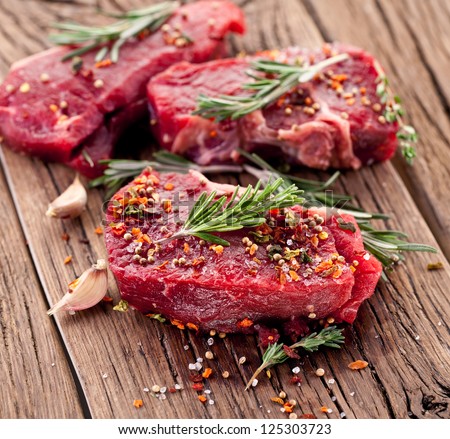 Raw Beef Steak On A Dark Wooden Table.