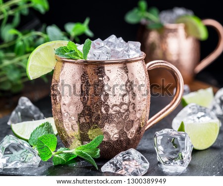Icy cold Moscow Mules cocktail in the cooper cup. Close-up.