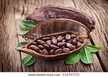 Cocoa pod on a dark wooden table.