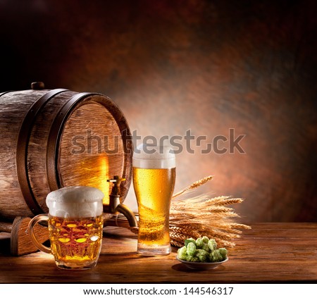 Beer Barrel With Beer Glasses On A Wooden Table. The Dark Background.