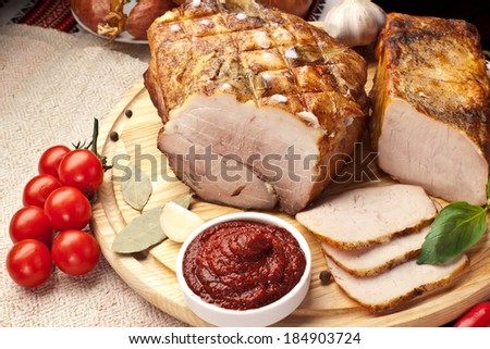 Different types of home-made pork arranged with sauce and vegetables.