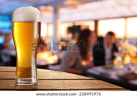 Photo of cold beer glass on the bar table.