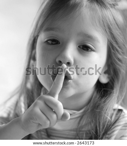 cute little girl with finger to lips