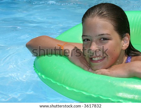girl in swimming pool with swim ring