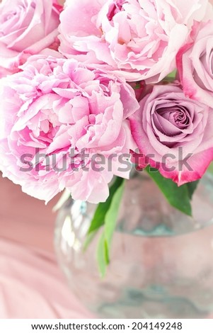 Floral composition with a pink peony and roses in a glass vase. Pink flowers.