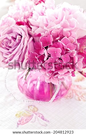 Floral composition with a pink peony ,hydrangea and roses in a glass vase. Pink flowers.