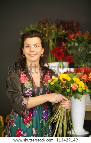 Female florist making a bouquet of flowers