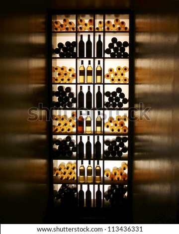 Wine bottles arranged on shelves with backlit