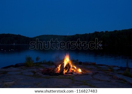 Campfire by lake at night