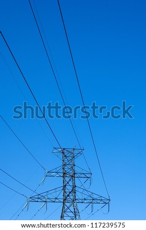 Low angle view on a transmission tower and power lines