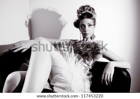 A glamorous woman sitting back in a chair