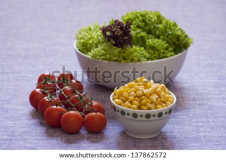 Close-up view of fresh mixed salad organic ingredients; salad, sweet corn, tomato