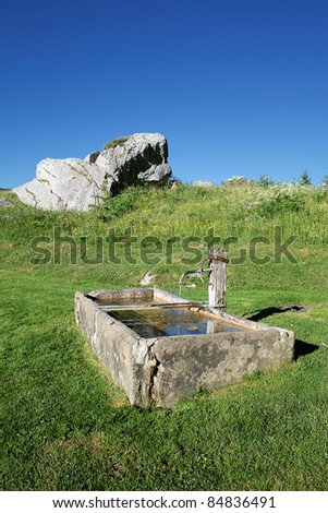Fountain with drinking water in alpine mountain