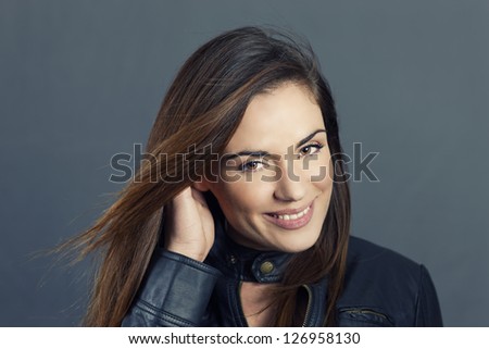 Glamour portrait of beautiful woman model with hand in hair