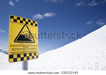 Snow ski resort caution sign on mountain