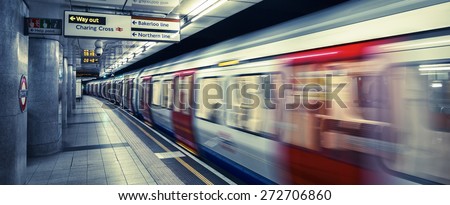 LONDON, UK -APRIL 19,  2015 : A moving train arriving at a London Underground station platform, special photographic processing.
