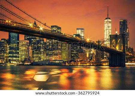 New York City Manhattan midtown at sunset with Brooklyn Bridge.