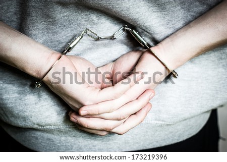 A young man in shackles