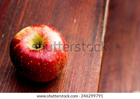 Red apple situated on the wood stair