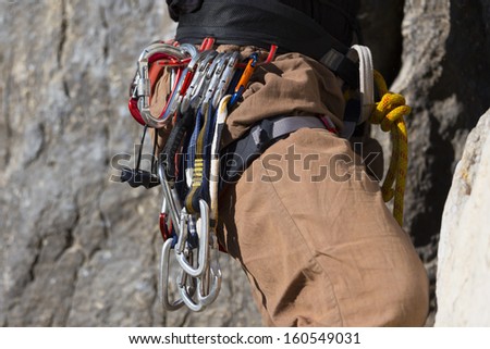 climber on the cliff wall with climbing equipment