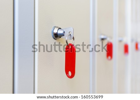closed changing room lockers doors with red key chains