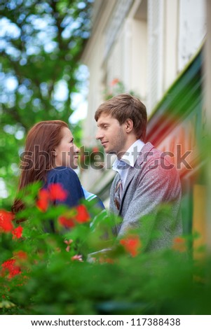 Man and woman together on balcony of their house or hotel
