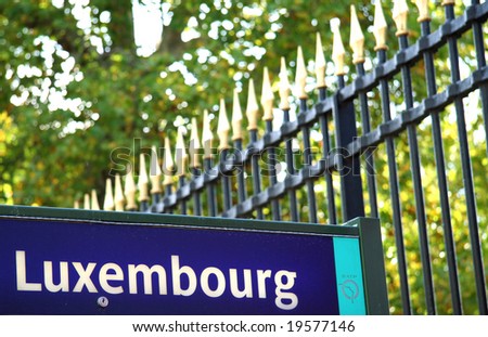 Luxembourg bus stop sign with the Luxembourg Garden grille in the background. Paris, France