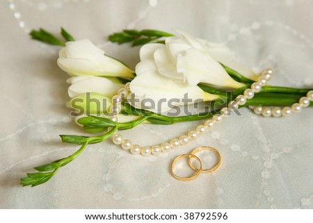 stock photo Wedding card Two golden rings with bridal veil and flowers