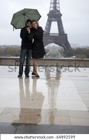 romantic couple kissing in rain. a couple kissing in the rain.