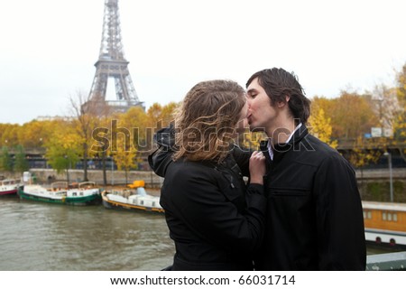 young couple kissing in rain. stock photo : Couple in Paris,