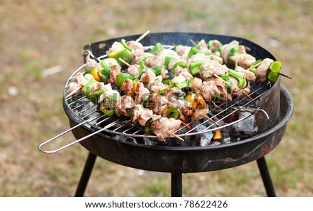 Grilling at summer weekend. Meet and fresh vegetables on grill