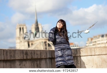 Happy brunette girl in Paris enjoying sunny spring day
