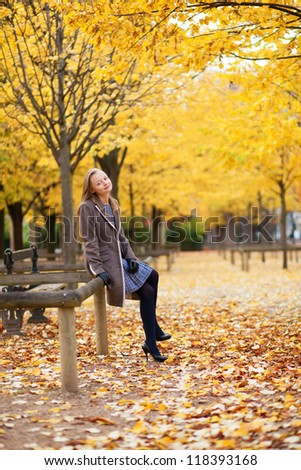 Pretty young girl enjoying a beautiful autumn day in Paris