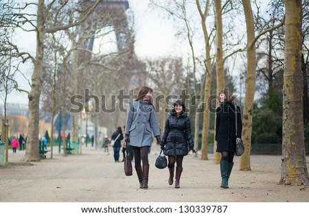 Three cheerful friends walking together in Paris