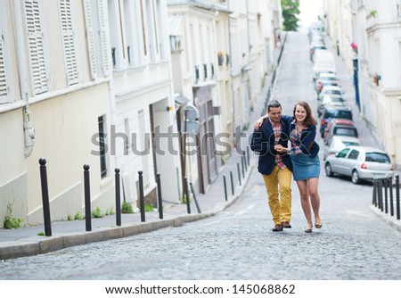 Happy couple walking together in Paris