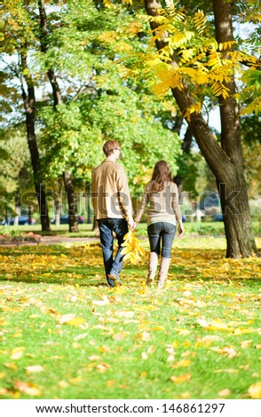 Couple walking in park on a fall day