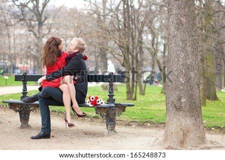 Happy romantic couple hugging on a bench