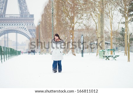 Girl walking in Paris on a snow day