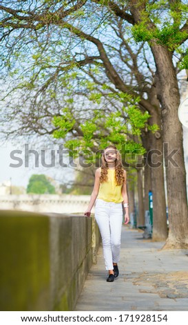 Girl walking by the Seine in Paris