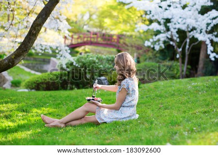Young woman eating sushi in Japanese park