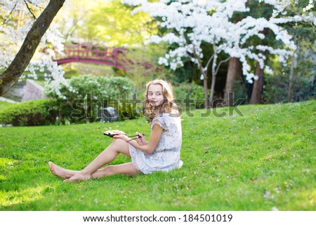 Young woman eating sushi in Japanese park.