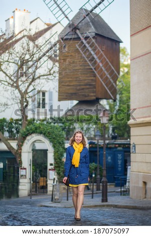 Happy young girl on a street of Montmartre.