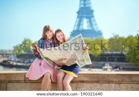 Two girls looking for direction in Paris.