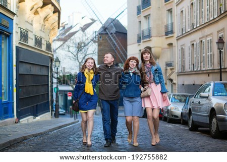 Four friends walking in Paris together
