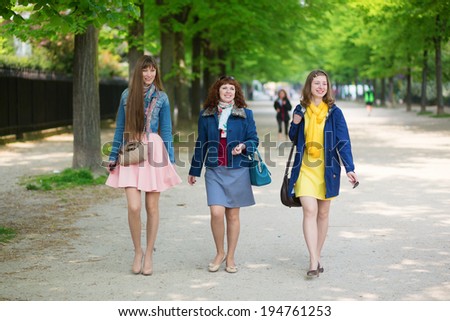 Happy friends walking together in Paris