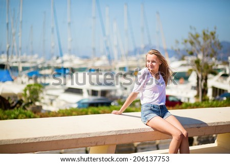 Nice looking young girl enjoying her vacation by the sea