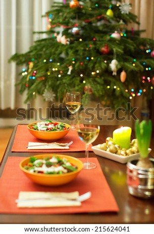 Decorated Christmas dining table with Christmas tree in background