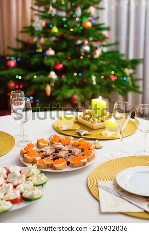 Decorated Christmas dining table with Christmas tree in background