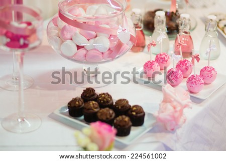 Pink cake pops on a dessert table at party or wedding celebration