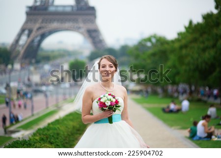Happy young beautiful bride in Paris, near the Eiffel tower